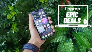 iPhone 15 Pro in hand with green rubber plants background